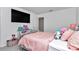 Bright bedroom with a TV, pink decor, and a comfortable bed, perfect for a room at 1795 Nw 44Th Ct Rd, Ocala, FL 34482