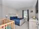 Cozy bedroom with hardwood floors, large window, and comfortable furnishings at 1795 Nw 44Th Ct Rd, Ocala, FL 34482
