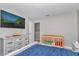Bedroom featuring wood crib, dresser, mounted TV, and a comfortable bed at 1795 Nw 44Th Ct Rd, Ocala, FL 34482