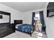 Cozy bedroom with natural light, black dresser, and bed at 1795 Nw 44Th Ct Rd, Ocala, FL 34482