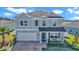 Beautiful two-story home features gray siding, attached garage, and a cozy front porch at 1795 Nw 44Th Ct Rd, Ocala, FL 34482