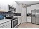 Modern kitchen featuring stainless steel appliances, white cabinets, and subway tile backsplash at 1795 Nw 44Th Ct Rd, Ocala, FL 34482