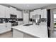 Bright kitchen featuring stainless steel appliances, white cabinets, granite counters, and island with sink at 1795 Nw 44Th Ct Rd, Ocala, FL 34482