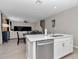 Kitchen island with stainless steel dishwasher and sink and view of the living room at 1795 Nw 44Th Ct Rd, Ocala, FL 34482