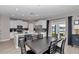 Open-concept kitchen and dining area featuring sleek white cabinets and stainless steel appliances at 1795 Nw 44Th Ct Rd, Ocala, FL 34482