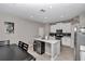 Well-lit kitchen with white cabinets, stainless steel appliances, tile backsplash and large kitchen island at 1795 Nw 44Th Ct Rd, Ocala, FL 34482