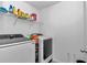 Convenient laundry room with front load washer and dryer, shelving, and ample storage space at 1795 Nw 44Th Ct Rd, Ocala, FL 34482
