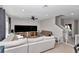 Open living room with a ceiling fan, natural light, and staircase access at 1795 Nw 44Th Ct Rd, Ocala, FL 34482