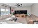 Spacious living room with a comfortable sectional couch, media center, and lots of sunlight at 1795 Nw 44Th Ct Rd, Ocala, FL 34482