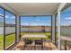 View of a screened-in patio with table and chairs overlooking the backyard at 1795 Nw 44Th Ct Rd, Ocala, FL 34482