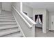 Carpeted staircase with white railing leading to the upper level of the home at 1795 Nw 44Th Ct Rd, Ocala, FL 34482