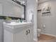 Stylish half bathroom featuring a modern sink, mirror, and neutral decor at 1838 Warringwood Dr # B-3, Orlando, FL 32839