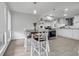 Dining area with a table and a view into the kitchen, featuring modern white cabinets at 1838 Warringwood Dr # B-3, Orlando, FL 32839