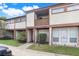 Inviting townhome featuring neutral siding, a cozy balcony, and a well-maintained front yard at 1838 Warringwood Dr # B-3, Orlando, FL 32839