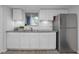 Modern kitchen featuring stainless steel appliances, granite countertops, and white cabinets at 1838 Warringwood Dr # B-3, Orlando, FL 32839
