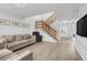 Spacious living room featuring wood-look flooring, a staircase, and contemporary decor at 1838 Warringwood Dr # B-3, Orlando, FL 32839