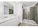 Bright bathroom featuring double sink vanity with quartz countertop and large shower with glass door at 222 Brave Rd, Davenport, FL 33837