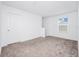 A carpeted bedroom with natural light from a window at 222 Brave Rd, Davenport, FL 33837