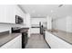 Modern kitchen featuring stainless steel appliances, white cabinets, and stylish gray countertops at 222 Brave Rd, Davenport, FL 33837