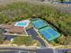 Aerial view of the community center with tennis courts, pool, and parking at 2368 Buckingham Run Ct, Orlando, FL 32828