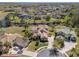 Aerial shot of a luxury home with a screened pool, surrounded by lush landscaping and a serene waterfront setting at 2368 Buckingham Run Ct, Orlando, FL 32828