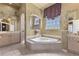 Bright bathroom featuring a large soaking tub with jacuzzi jets, dual vanities, and custom decorative accents at 2368 Buckingham Run Ct, Orlando, FL 32828