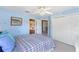 Bright bedroom with colorful accent wall, ceiling fan, and ensuite bathroom and closet at 2368 Buckingham Run Ct, Orlando, FL 32828