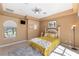 Cozy bedroom features neutral paint, natural light, and a ceiling fan at 2368 Buckingham Run Ct, Orlando, FL 32828