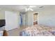 View of a bedroom with floral bedspread with access to an ensuite bath and a wardrobe at 2368 Buckingham Run Ct, Orlando, FL 32828