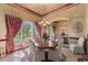 Elegant dining room with large windows, a wooden table with seating for six, and decorative lighting at 2368 Buckingham Run Ct, Orlando, FL 32828
