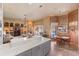 Open kitchen and living room with marble countertops, tile flooring, and fireplace overlooking the pool at 2368 Buckingham Run Ct, Orlando, FL 32828