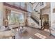 Elegant living room with soaring ceilings, large windows, and a grand staircase at 2368 Buckingham Run Ct, Orlando, FL 32828