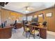 Home office with striped wallpaper, wood desk, two chairs, and multiple diplomas on the wall at 2368 Buckingham Run Ct, Orlando, FL 32828