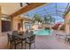 Luxurious covered pool area with cascading waterfall feature and ample seating at 2368 Buckingham Run Ct, Orlando, FL 32828