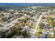 An aerial view shows the property's location in a neighborhood with a nearby lake in the distance at 2665 Windsor Heights St, Deltona, FL 32738