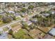 Aerial view showing the house in a neighborhood with mature trees and green lawns at 2665 Windsor Heights St, Deltona, FL 32738