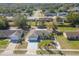 An aerial view of a well-maintained house in a suburban neighborhood with lush greenery at 2665 Windsor Heights St, Deltona, FL 32738