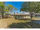 Exterior view of house with trees and grass in the yard at 2665 Windsor Heights St, Deltona, FL 32738