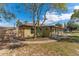 Exterior view of house with fence and view of sunroom at 2665 Windsor Heights St, Deltona, FL 32738