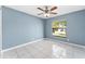 Bedroom with white tile flooring and a bright window at 2665 Windsor Heights St, Deltona, FL 32738