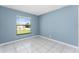 Bedroom featuring white tile flooring and a bright window at 2665 Windsor Heights St, Deltona, FL 32738