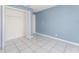 Bedroom featuring neutral walls, white tile flooring and a closet at 2665 Windsor Heights St, Deltona, FL 32738