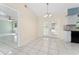 Bright dining area featuring a modern chandelier and French doors, adjacent to the kitchen at 2665 Windsor Heights St, Deltona, FL 32738