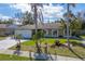 Well-kept house featuring a two-car garage, mature trees, and a green front yard at 2665 Windsor Heights St, Deltona, FL 32738
