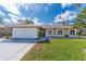 Charming single-story home with a well-manicured lawn and a two-car garage at 2665 Windsor Heights St, Deltona, FL 32738