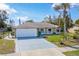 Beautifully maintained home featuring an attached two-car garage and a lush front yard at 2665 Windsor Heights St, Deltona, FL 32738