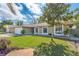 Inviting home exterior with lush lawn, mature tree, and ample natural light at 2665 Windsor Heights St, Deltona, FL 32738
