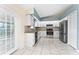 Bright kitchen with stainless steel refrigerator, white cabinetry, and tiled floor at 2665 Windsor Heights St, Deltona, FL 32738
