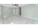 Bright living room featuring neutral walls and white tile flooring, complemented by a ceiling fan at 2665 Windsor Heights St, Deltona, FL 32738