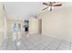 Spacious living room showcasing tile flooring and seamless access to dining and kitchen areas at 2665 Windsor Heights St, Deltona, FL 32738